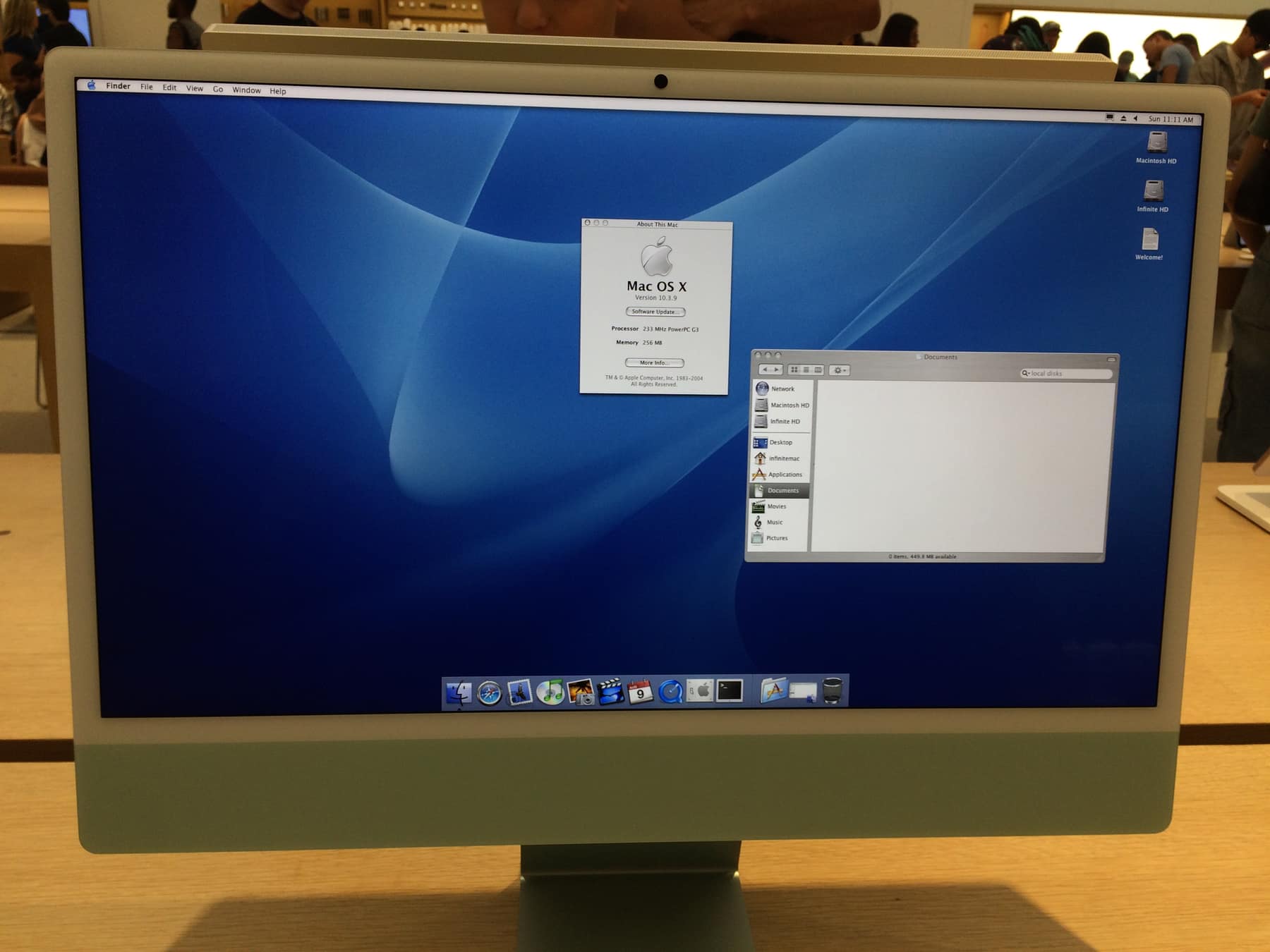 An iMac in an Apple Store running a Mac OS X 10.3 desktop... supposedly